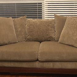 Sage Green Couch With Cherry Wood Feet And Accents 