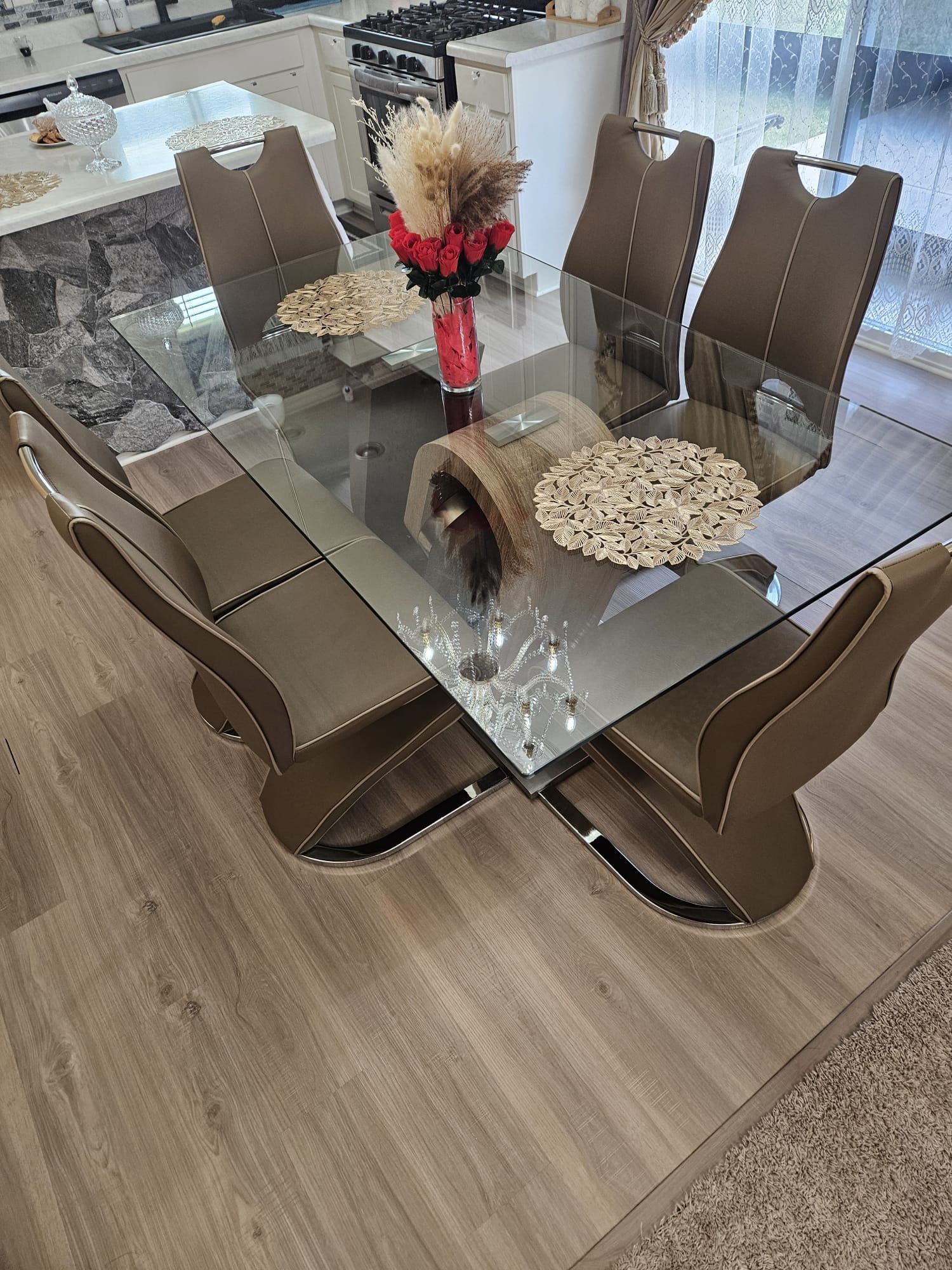 Glass dining table with 6 brown chairs