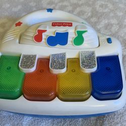 1999 FISHER PRICE Vintage light up top piano from Fisher Price. Press  keys  colorful lights dance as one of 5 songs are played. Includes classical se