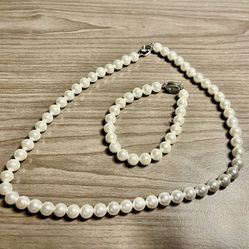 elegant pearl necklace and bracelet set adds a touch of sophistication to any outfit. Perfect for any occasion. Happy to bundle. I do see a mark 