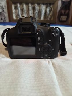 Canon Rebel T100 ESO DLSR camera set with extra lens and single sling backpack carrying case