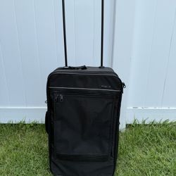 Small black rolling luggage by Delsey