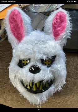 creepy, white faux-fur Halloween killer bunny mask featuring pink-lined ears, menacing yellow-green teeth, and button-like eyes.