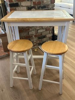 Small White kitchen table with 2 stools.