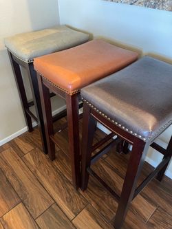 3 Bar Stools for Sale – $35 Each  Beautiful bar stools in good condition. Comfortable padded seats with sturdy wooden legs. Three different neutral co