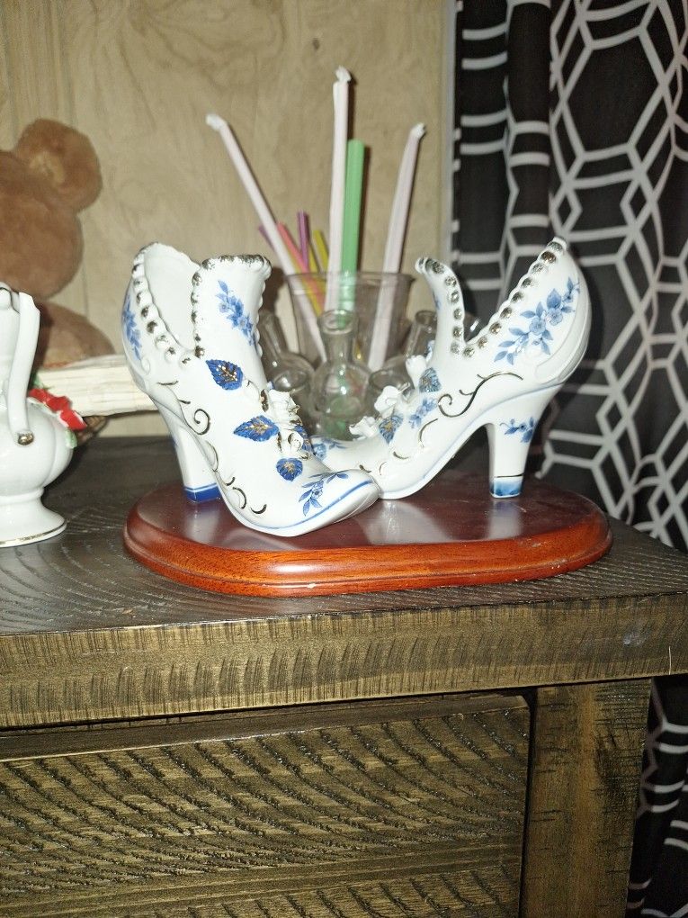 Vintage porcelain shoes, 5” high, embellished with blue, white & gold accents