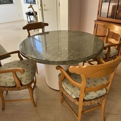 Round granite table four coordinating chairs