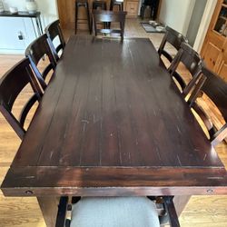 Solid wood distressed Dining Table w/ 8 chairs to match.