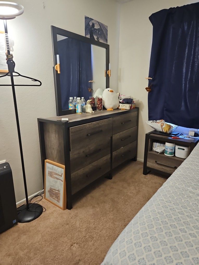 Brown wooden dresser with attached mirror