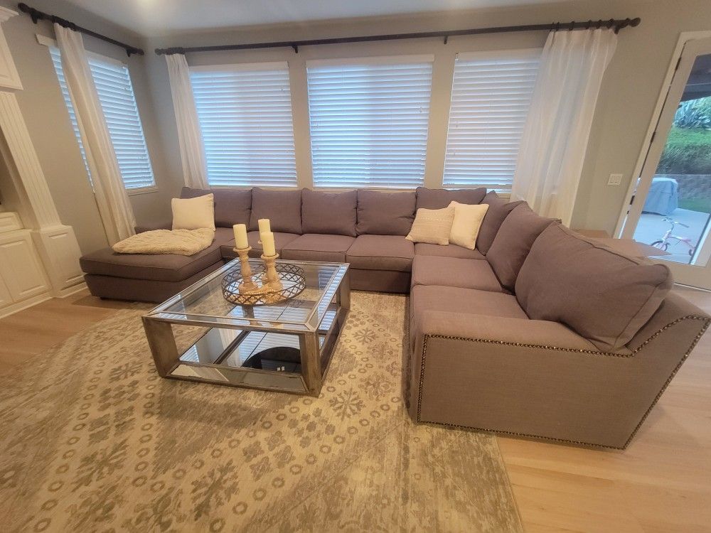 Grey sectional couch with chaise lounge.