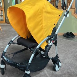 Bugaboo bee yellow & black stroller. Has some scratches/scuffs, minor rust on springs & a few stains - see pics! 