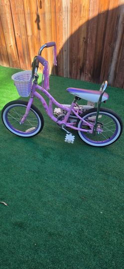 Schwinn Bloom 16-inch Kid's Bike in a purple and pink colorway, featuring a front wicker-style basket, handlebar tassels, and a classic low-rider/bana