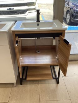 24” bathroom vanity cabinet new pvc wood. Color with white ceramic top sink integrated can be Wallmount or freestanding ready for pick up today