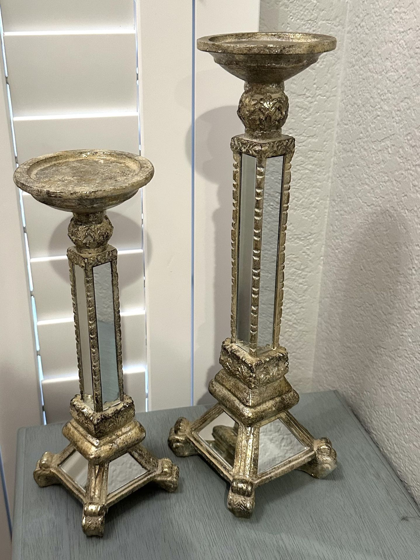 $5 - Set of 2 Elements mirror and gold Pilar candle holder. Small is 12” and the large one is 15.5”. Please pickup in the area of 36th Ave and Pinna