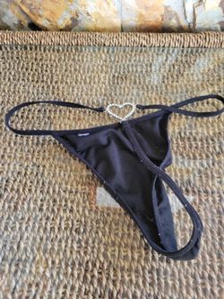 Black Victoria's Secret Very Sexy rhinestone thong features a prominent heart-shaped crystal charm