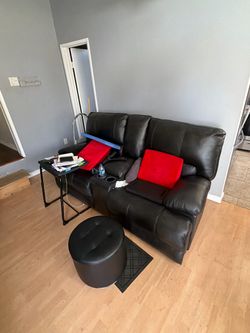 Like new black leather love seat recliner