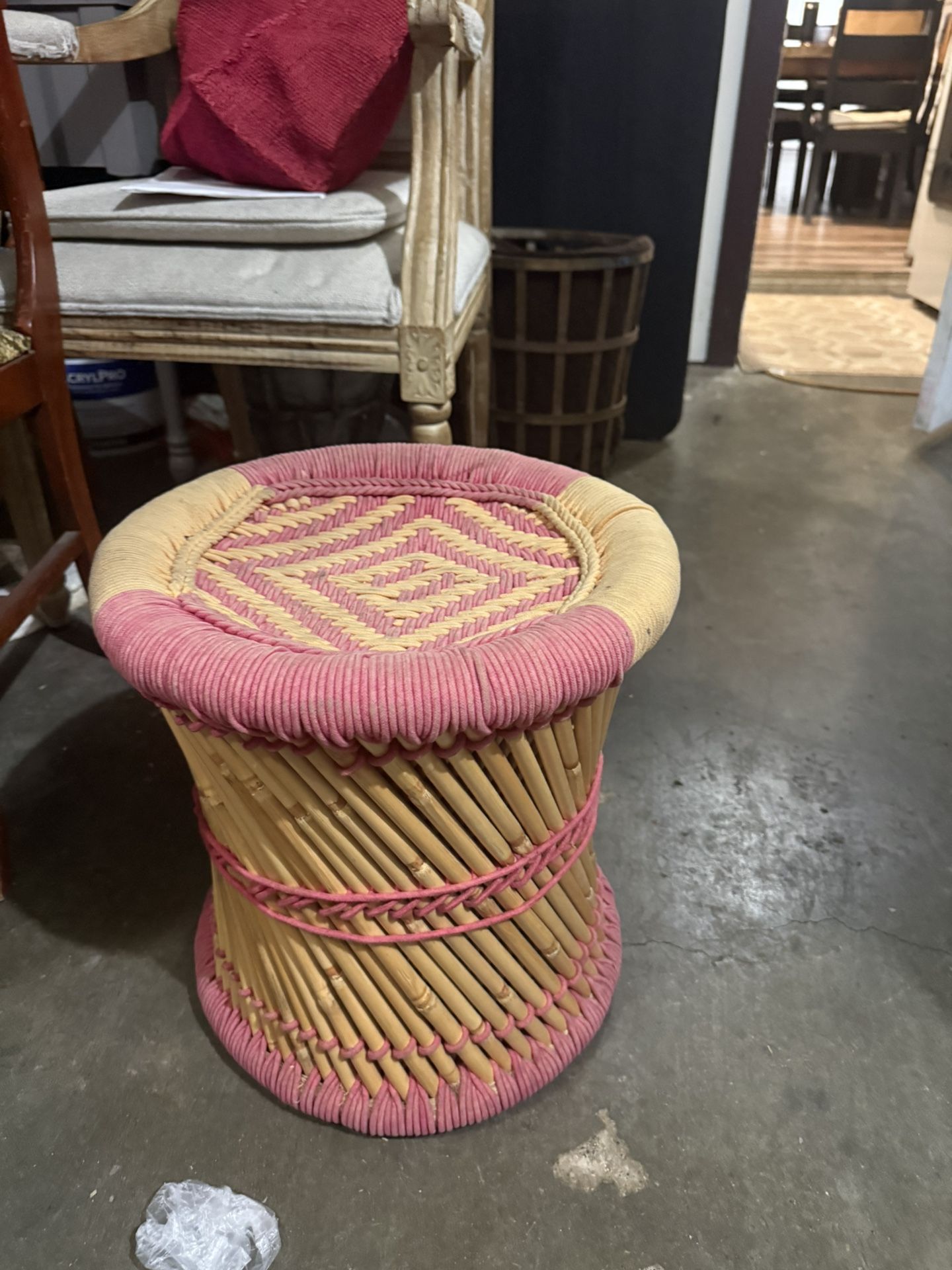Pink and natural woven bamboo stool.