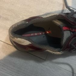 Stylish Prada men's sneakers. Burgundy patent leather with gray mesh accents. Comfortable and trendy design. Size 10.5