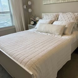 Queen size wood bed frame with bed base and mattress.