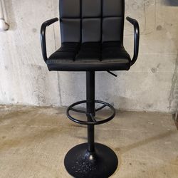 Black, adjustable bar stool