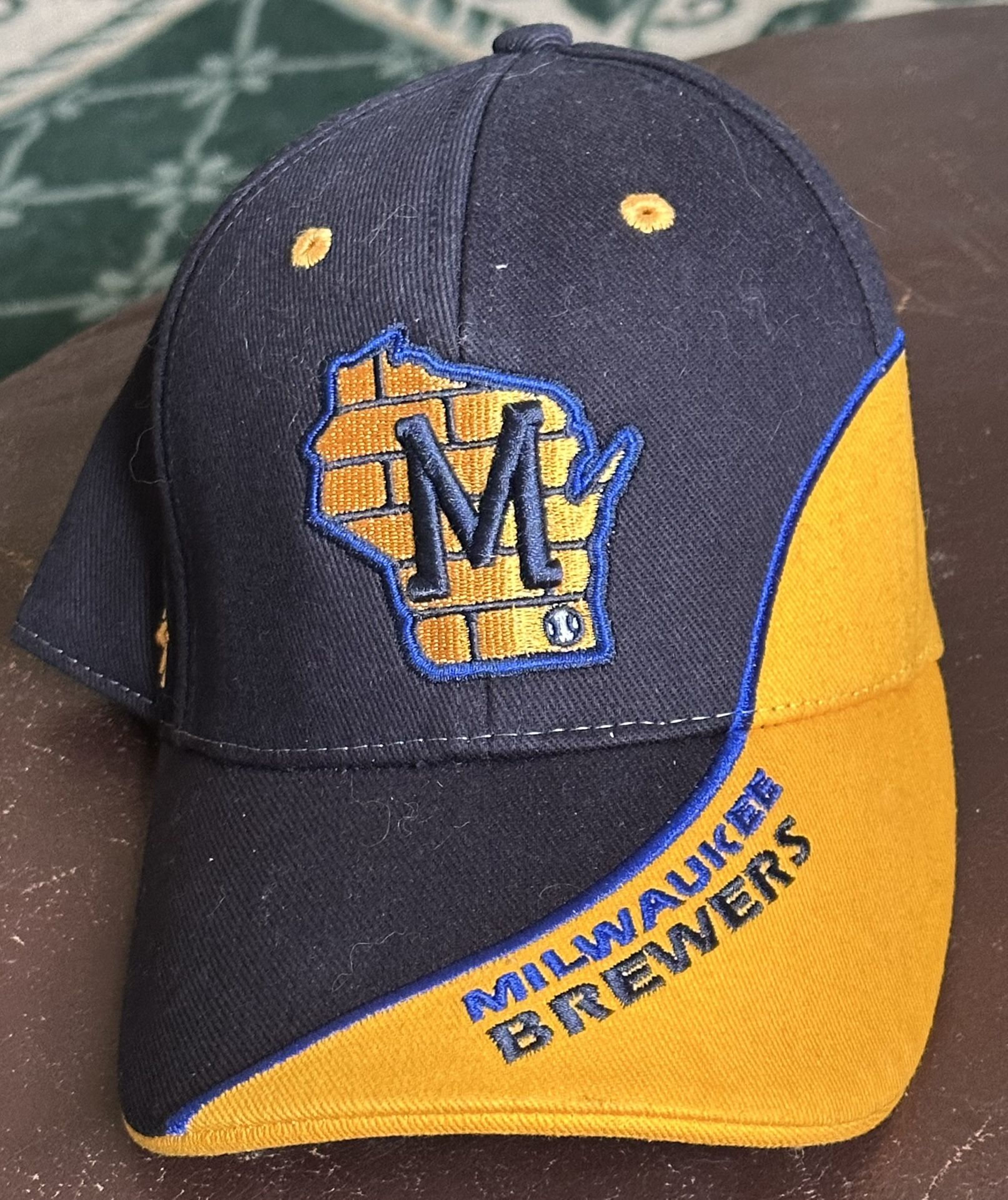 Milwaukee Brewers baseball cap featuring a logo in the shape of the state of Wisconsin.