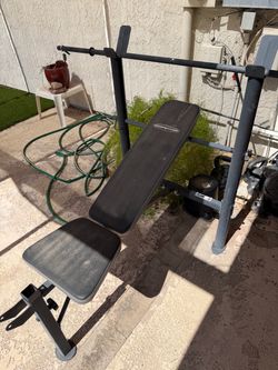 Standard weight bench with bar and  a set of 15 lb weights and 25 lb weights