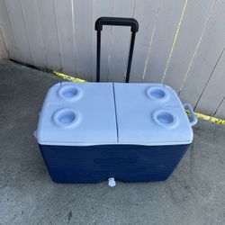 Blue 60 quart Rubbermaid rolling ice chest 