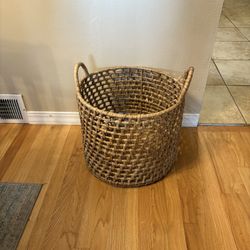 round, open-weave water hyacinth storage basket with handles. 