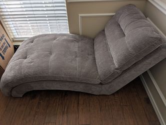 Chaise in a grey microfiber fabric with square tufting.