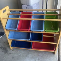Wooden shelf organizer with plastic boxes for room children’s room