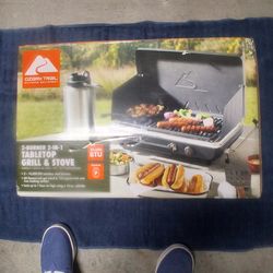 NEW "OZARK TRAIL" DUAL BURNER 20,000 BTU'S PROPAINE TABLE TOP GRILL AND STOVE, 60 SQUARE INCH POT STAND AND 122 SQUARE INCH CAST IRON COOKING SURFACE,