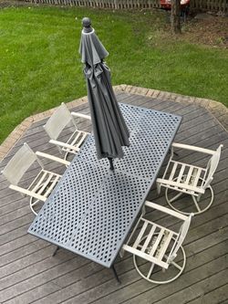 Outdoor table, chairs, and patio umbrella