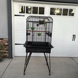 Tall black metal bird or parrot cage on rolling stand