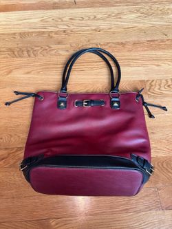 burgundy faux leather satchel features prominent black trim