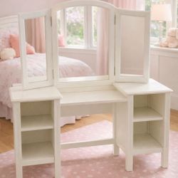 Beautiful Pottery Barn Kids vanity in classic white with tri-fold mirror and side shelving. This is a high-quality, solid piece that looks lovely in a