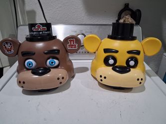 The Five Nights at Freddy's Golden Freddy Collector Bundle storage head by PhatMojo,  and  the Freddy Fazbear head .  Featuring electronics light up a