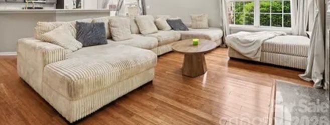 Beige U shaped sofa with ottoman