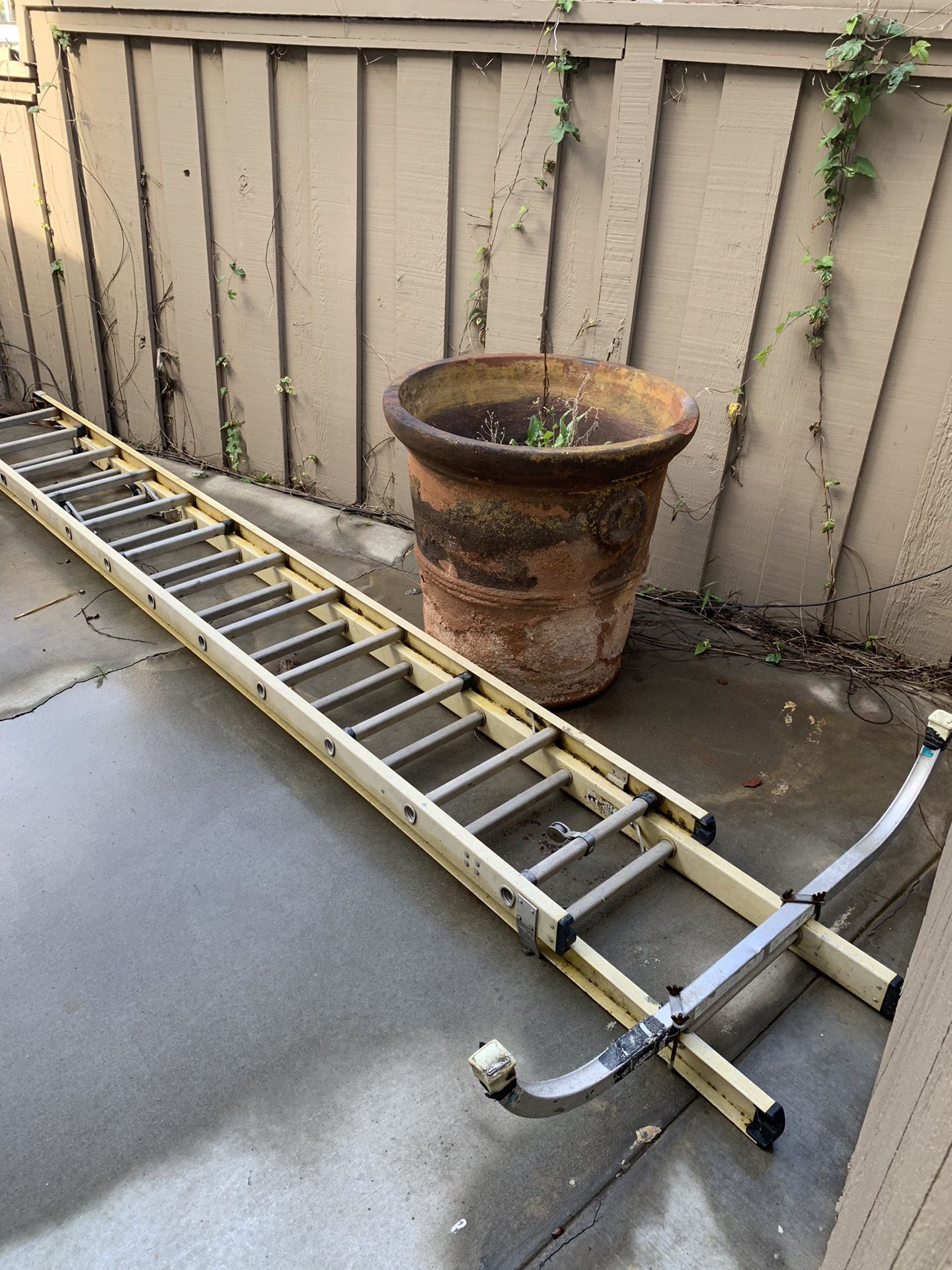 Extension ladder with braces. Needs new rope. $150.