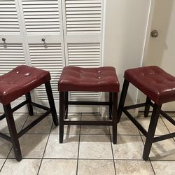 Three Burgundy stools (H: 24.5 in, W: 14 in, L: 20 in)