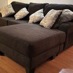 Brown couch with detachable extension and pillows