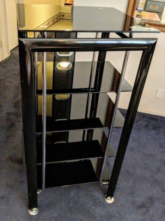 Entertainment center, black with 5 glass shelves. Very nice and heavy.