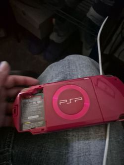 deep red Sony PSP-2001 God of War Limited Edition handheld console featuring a white graphic of Kratos on the back.