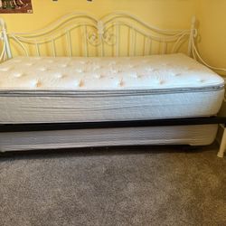 White Rod Iron Twin Bed With A Trundle bed Underneath