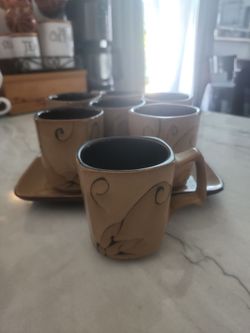 7 brown mugs and a plate
