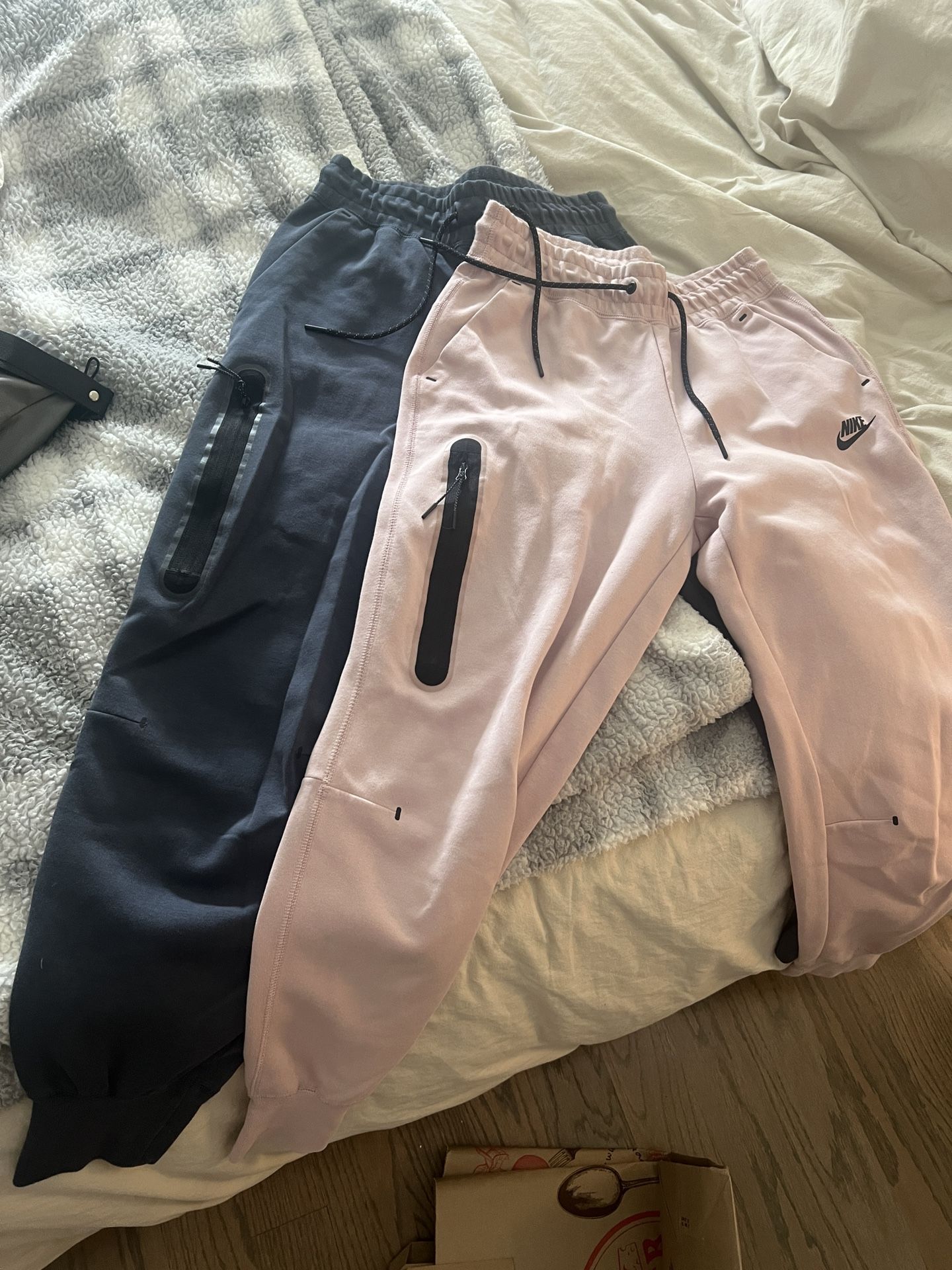 2 pairs of nike tech joggers