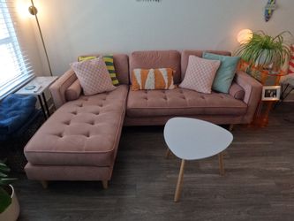 Dusty-pink tufted sectional sofa with chaise