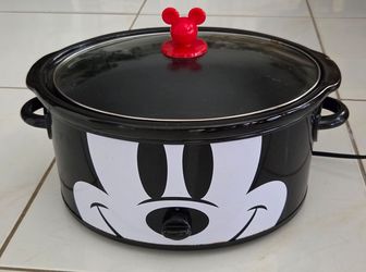Disney Mickey Mouse 6‑quart slow cooker, works. Ceramic inner pot has a small chip on the rim, please see picture. Not a toy, keep away from children.