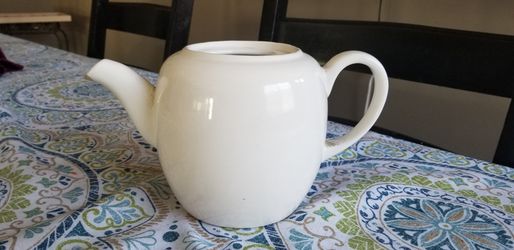 White ceramic teapot. Decor, flower arrangements