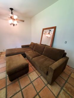 Brown sectional couch with chaise and ottoman