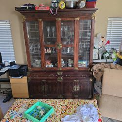 Chinoiserie-style china cabinet with brass hardware. 